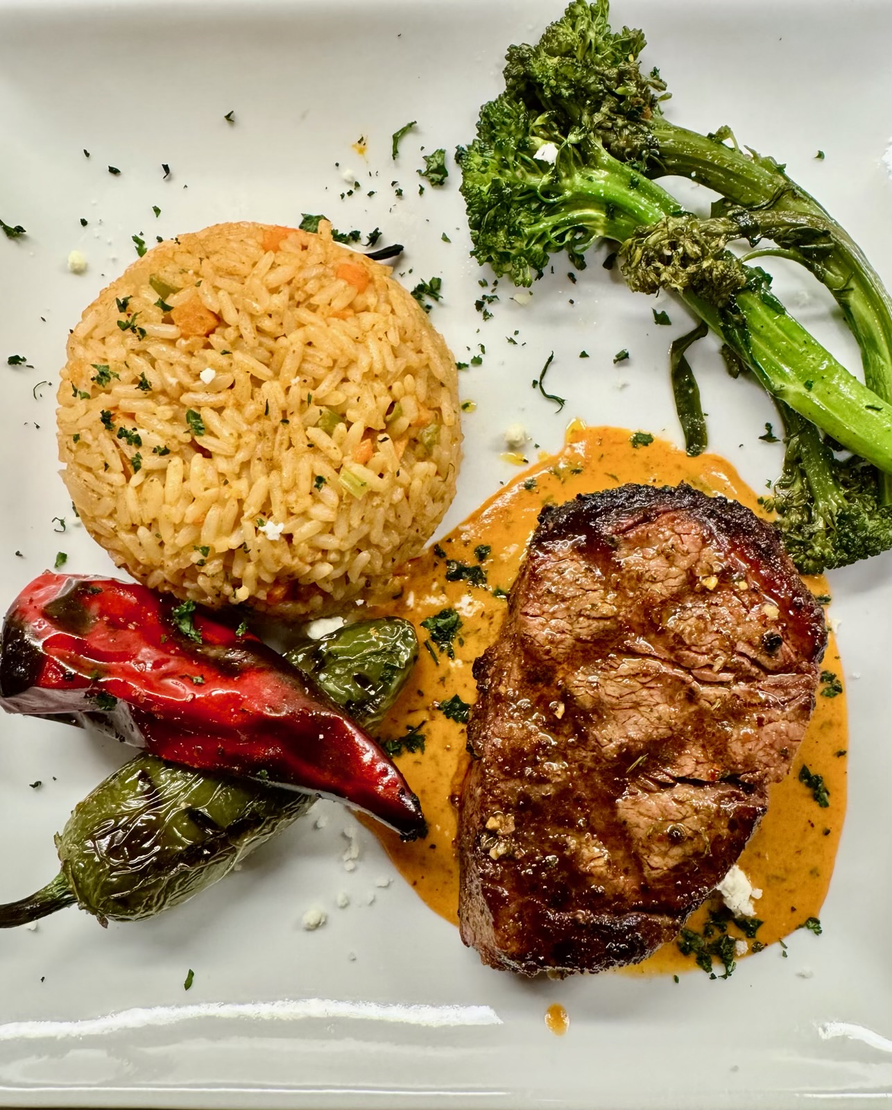 Seared filet in chile cream sauce with rice pilaf and blistered peppers